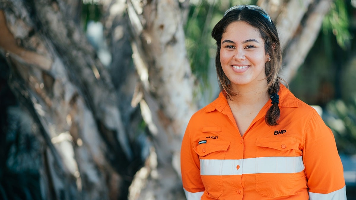 Geology graduate shown in front of tree at Saraji mine